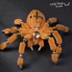 Handmade black spider decoration made with pipe cleaners, featuring crystal bead embellishments in green, amber, and yellow. Perfect for Halloween decor or a unique desk ornament